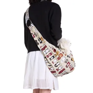 Detail view of breathable crossbody pet sling bag with cute dog print and metal ring.