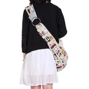 Canvas pet sling bag with cute dog print and metal ring, comfortable single shoulder design.