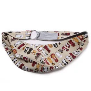 Breathable canvas pet sling carrier with cute dog pattern and metal rings for outdoor puppy travel.