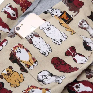 Canvas pet sling bag detail showing cute dog pattern print, front pocket and durable fabric design.