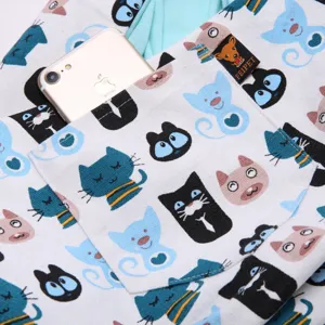 Detailed view of the pet sling bag featuring cute cat patterns and a handy phone pocket.