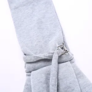 Close up view of grey pet carrier sling strap with metal adjustable rings and loops detail.