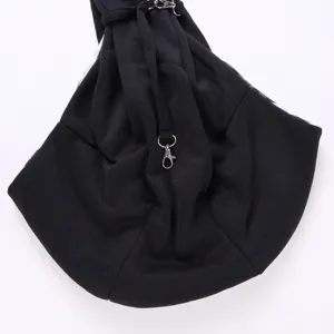 Close-up detail of the black pet sling bag showing durable metal clasp and breathable fabric.