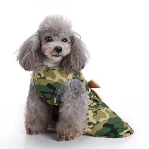 Detail view of a small poodle wearing a green camouflage pet dress for summer.