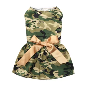 Close-up detail of camouflage pet dress with a prominent gold satin bow decoration