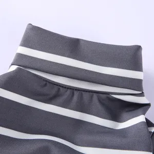 Detailed close-up of grey and white striped pet turtleneck clothing collar and texture.