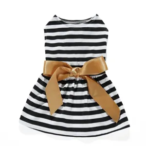 Detailed macro view of black and white striped pet dress featuring a large gold satin bow
