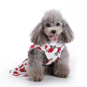 Close-up of cute floral pet dog dress with red rose prints for summer, white puppy skirt