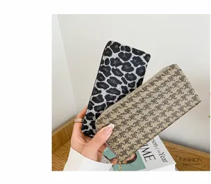 Detailed close-up of linen clutch bags featuring stylish leopard print and plaid textures.
