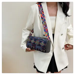Model met vintage canvas crossbodytas met etnisch patroon en brede schouderriem