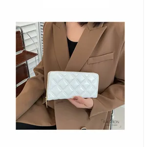 Detail view of a stylish white quilted long wallet clutch for women with elegant gold zipper