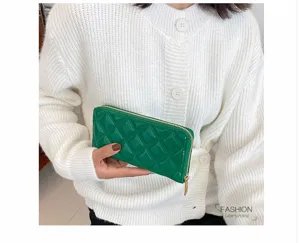 Detailed macro view of a vibrant green embossed diamond quilted long zip-around lady's purse