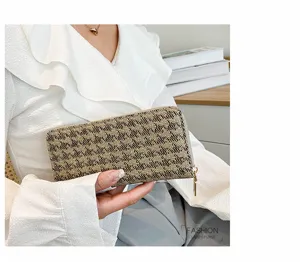 Detail view of a women's elegant flax checkered long wallet clutch with gold zipper