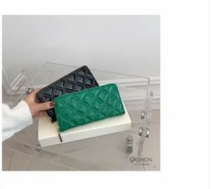 Elegant quilted patent leather long wallets for women in glossy black and green.