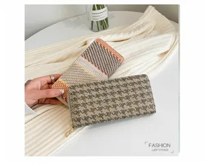 Close-up of woven linen clutch purses in plaid and houndstooth patterns for women