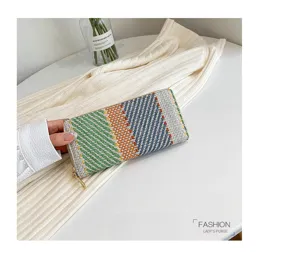 Detailed view of women's woven linen clutch featuring colorful striped pattern