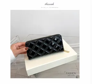 Detailed view of an elegant glossy black quilted long wallet for women with gold zipper.