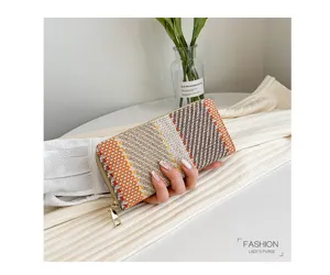 Hand-held woven lady's purse with orange and beige check pattern detail