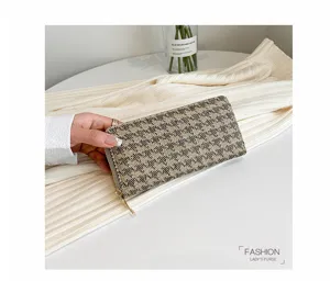 Detailed view of women's linen houndstooth clutch wallet with zip-around closure