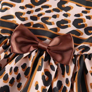 Close-up detail of pet summer dress featuring leopard print fabric and a brown satin bow.