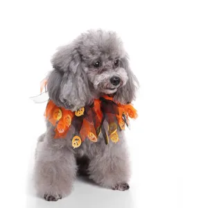 Close-up of Halloween pet collar with orange mesh and pumpkin charms on a grey poodle