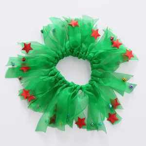 Macro view of green Christmas pet collar featuring red stars and decorative bells