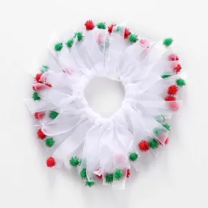 Detailed close-up of white mesh pet ruff featuring festive red and green decorative pom-poms