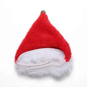 Detailed macro view of a red plush pet Santa hat featuring white fur trim and a small gold bell