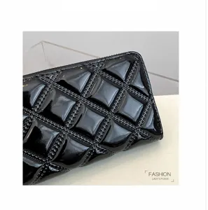 Close-up of black patent leather long wallet with elegant quilted diamond pattern