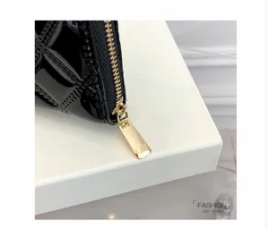 Close-up of golden zipper on black diamond quilted patent leather purse for women
