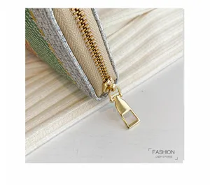 Macro detail of high-quality golden metal zipper on colorful checkered linen lady's purse