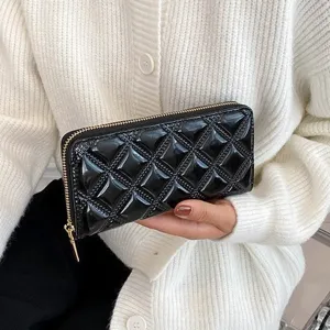 Elegant black quilted patent leather long wallet with gold zipper detail for women