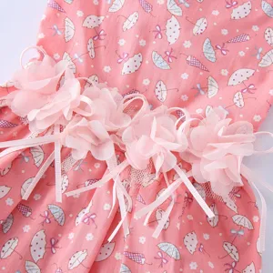 Détail charmant de robe pour animal rose avec imprimé parapluie mignon et ceinture en tulle.