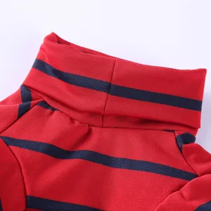 Close-up detail of soft red and navy blue striped turtleneck pet clothing fabric.