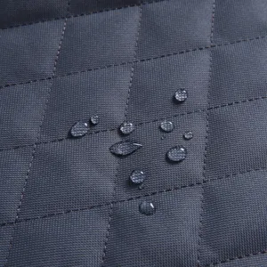 Waterproof pet car seat mat fabric detail, durable quilted grey dog car cover surface.