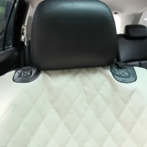 Waterproof quilted pet car seat cover detail showing durable beige fabric and strong straps.