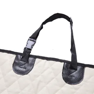Pet car seat cover detail strap buckle and quilted beige fabric reinforcement patch close up