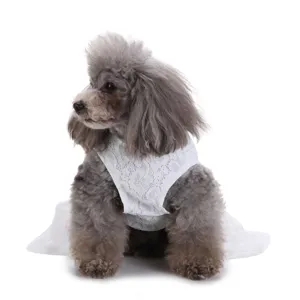 Detailed side view of a white floral lace summer pet dress on a small gray poodle