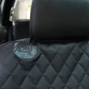 Waterproof pet car seat cover detail showing durable diamond quilted fabric and strap.