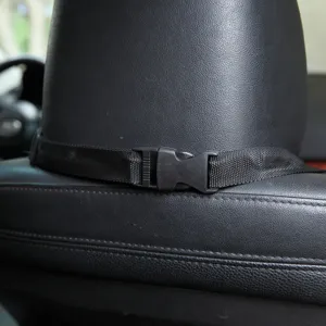 Detail view of the black nylon strap and plastic buckle for secure pet car seat installation.