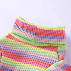 Close-up of colorful striped dog turtleneck sweater, showing soft ribbed knit fabric texture.