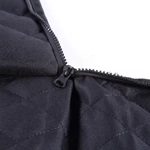 Detail view of black quilted pet car seat cover zipper, showing durable waterproof fabric.