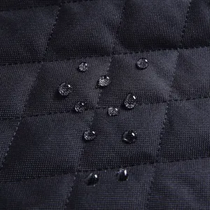 Waterproof pet car seat cover detail showing high performance black quilted fabric material.