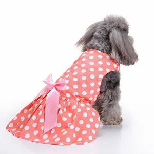 Macro back view detail of a coral pink polka dot dog dress with a large satin bow