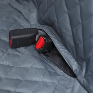Close-up detail shot of grey quilted pet car seat cover showing convenient seatbelt buckle opening.