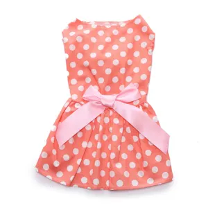 Detailed view of cute coral pink polka dot pet dress with a large satin bow