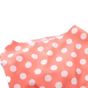 Close-up detail of coral polka dot pet dress neckline showing fine stitching quality.