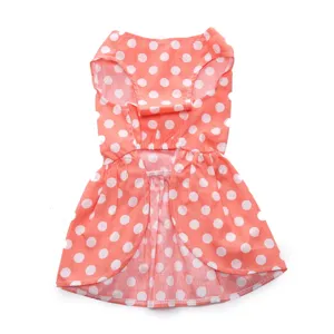 Macro detail showing the vibrant pink fabric and white polka dot print of the pet summer skirt