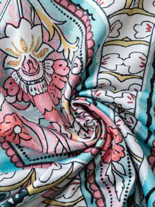 Vintage floral print long dress fabric detail showing rich colors and soft texture, boho style.
