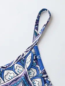 Detailed close-up of a women's vintage floral print camisole strap and neckline edge.